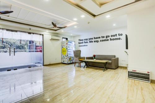 a living room with a table and a couch at Hotel GreySky Near Medanta Hospital in Gurgaon