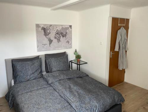 a bedroom with a bed and a map on the wall at Op Nijverdal in Nijverdal