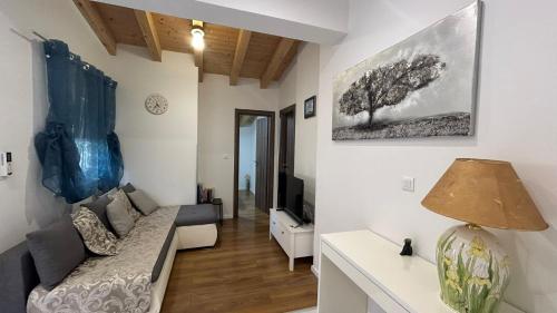 a living room with a couch and a tv at by Osibov, holiday home near Split with pool in Kaštela