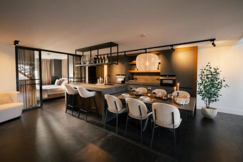 a kitchen and living room with a table and chairs at Het-Boothuys in Harderwijk