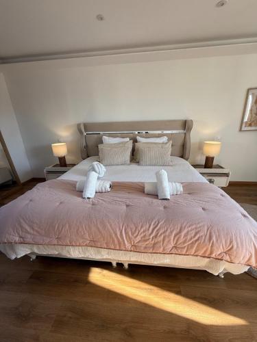a bedroom with a large bed with two towels on it at L ecrin de Rosheim, villa d exception, piscine in Rosheim