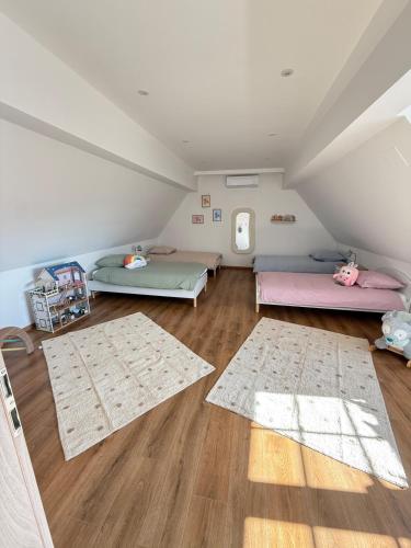 a attic room with two beds and two rugs at L ecrin de Rosheim, villa d exception, piscine in Rosheim
