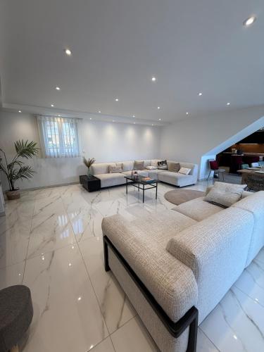 a large living room with a large bed and a couch at L ecrin de Rosheim, villa d exception, piscine in Rosheim