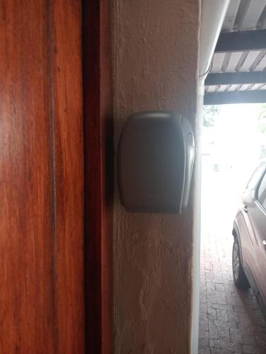 a tv on the side of a wall at The Pool Cottage in Fish hoek