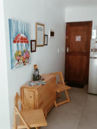 a room with a table and a chair and an umbrella at The Pool Cottage in Fish hoek