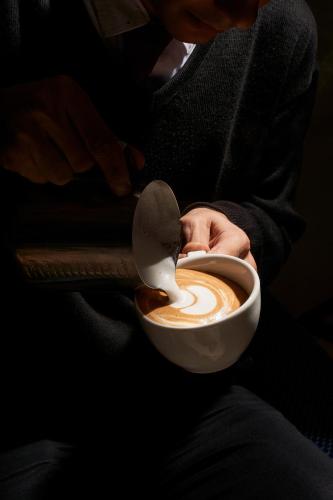 a person is drinking a cup of coffee at Pyramids Park Resort Cairo in Cairo