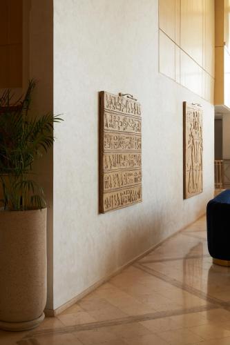 two pieces of art on a wall in a room at Pyramids Park Resort Cairo in Cairo