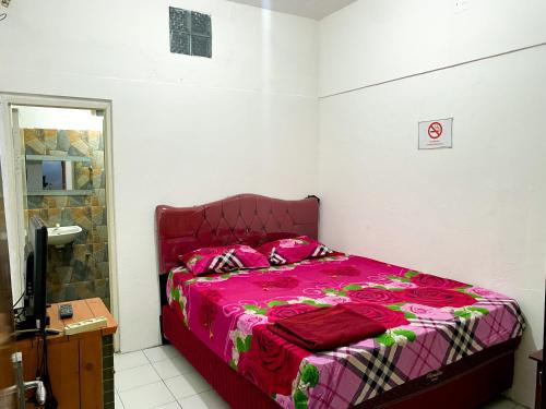 Postel nebo postele na pokoji v ubytování Parikesit Guest House
