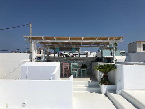 a white building with a shelter on top of it at Sandora in Agios Prokopios