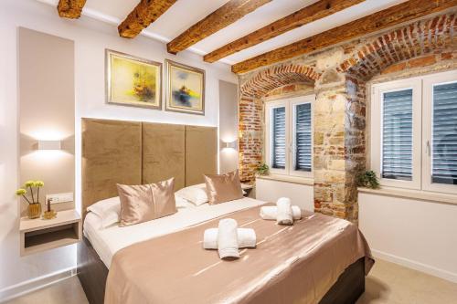 a bedroom with a large bed in a room with windows at Apartment eVaLa in Split