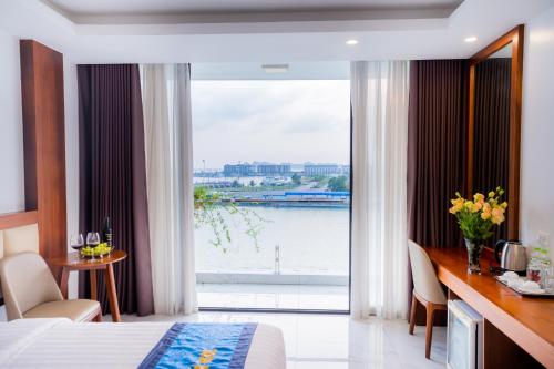 a hotel room with a view of the water at Hạ Long Land Hotel in Ha Long