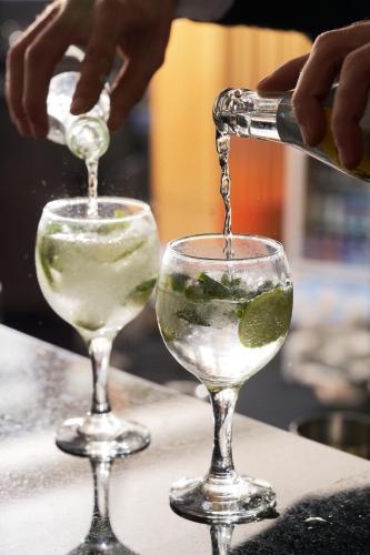 a person pouring a drink into a wine glass at Pyramids Park Resort Cairo in Cairo