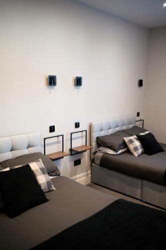 a bedroom with two beds and a table with mirrors at Stunning Sea View Apartment With Balcony & Parking in Rhos-on-Sea