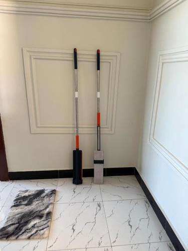 a room with two shovels on the wall at MASAI Apartment Goba in Dar es Salaam