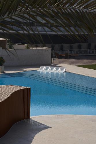 a swimming pool with blue water in a building at Pyramids Park Resort Cairo in Cairo