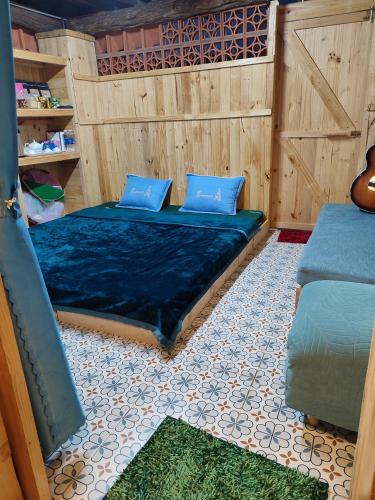a room with two beds with blue pillows at Natural Garden BMT in Buon Ma Thuot