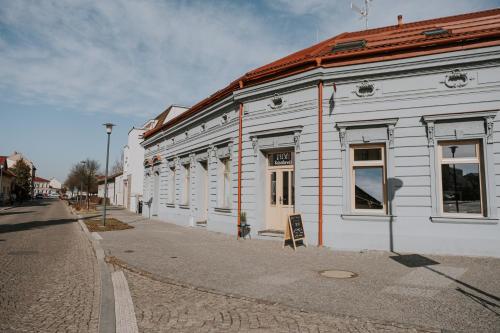 a white building on the side of a street at Kavárna a penzion Orava in Karviná