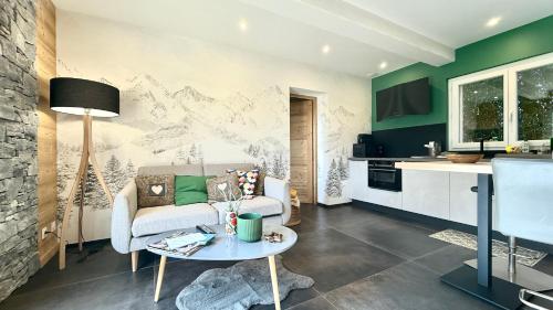 a living room with a couch and a table at Havre de paix de la Lierre in Fillinges