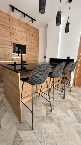 a kitchen with chairs and a table with a sink at Apartment Holiday La Mata in La Mata