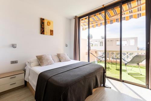 a bedroom with a bed and a large window at Paradise Suite - Costa Adeje in Adeje