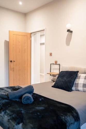 a bedroom with two beds and a door to a room at Stunning 2 Bedroom Beach Apartment With Garden in Rhos-on-Sea