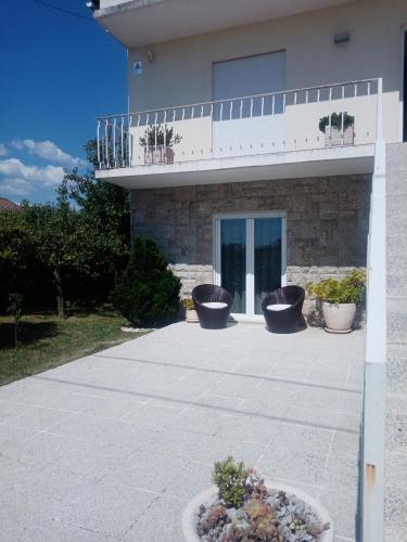 a building with three flower pots in front of it at Casa do Campo in Seia