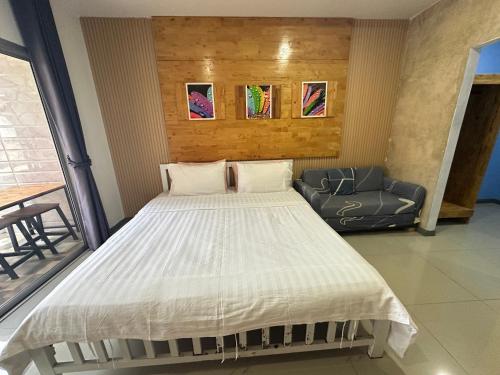 a bedroom with a large bed and a couch at Jingle Bells Resort in Ko Larn