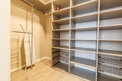 a walk in closet with gray shelves at Amber Apartment in Riga