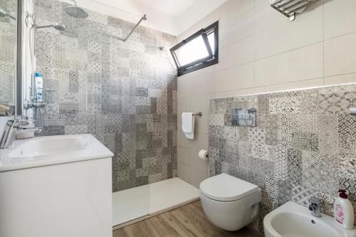 a bathroom with a toilet and a sink and a shower at Paradise Suite - Costa Adeje in Adeje