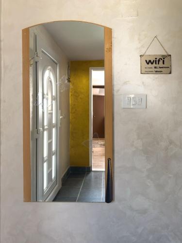 a mirror on the wall of a hallway at Apartman HILL 3 in Golubac