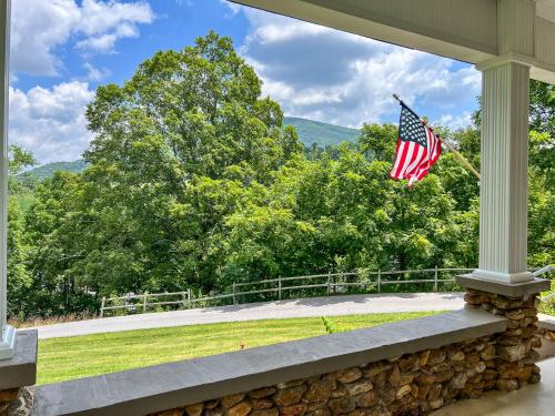 an american flag on the porch of a house at Walnut Hill in West Jefferson