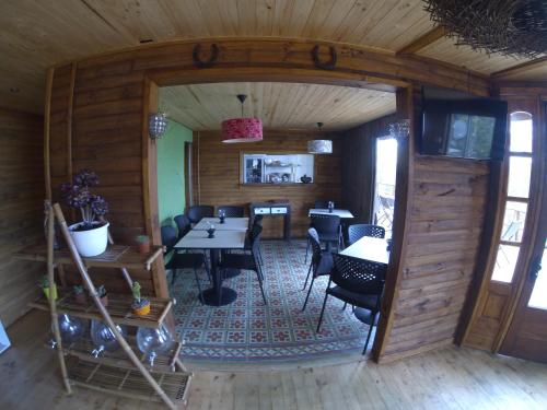 a dining room with tables and chairs in a cabin at Cabañas & SPA Carilafquen in Laguna Verde