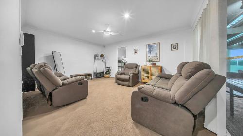 a living room with two chairs and a television at Blue Willow Bathurst Country Getaway in Bathurst