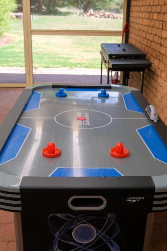 a ping pong table with a ping pong ball at Blue Willow Bathurst Country Getaway in Bathurst