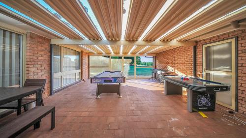 a patio with a pool table and ping pong tables at Blue Willow Bathurst Country Getaway in Bathurst