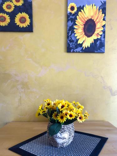 a vase filled with yellow flowers sitting on a table at Apartman HILL 3 in Golubac