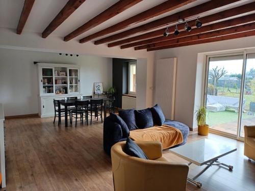 a living room with a couch and a table at Bienvenue à la maison ! in Mulsanne