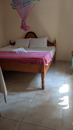 a bedroom with a wooden bed in a room at Vista villa in Panama