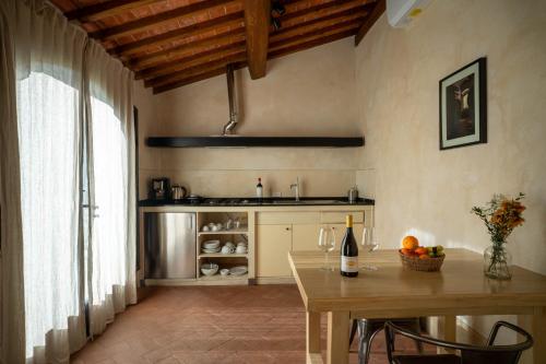 a kitchen with a table with a bottle of wine at Tenuta San Jacopo - Agriturismo in Cavriglia