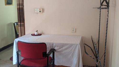 a table with a red chair in a room at Vista villa in Panama