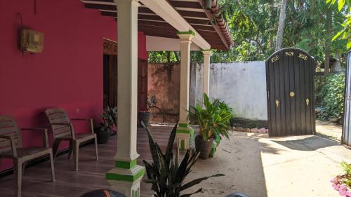 a porch with chairs and a pink house at Vista villa in Panama