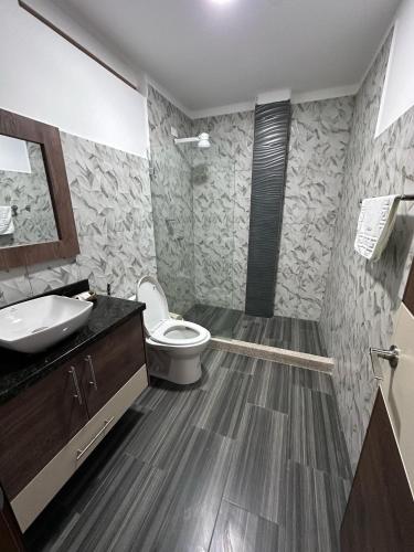 a bathroom with a toilet and a sink at Hotel Playa Dubai Golden Suite in Cojimíes