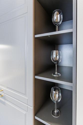 a cupboard with wine glasses in it at Elegant Apartment in Rīga