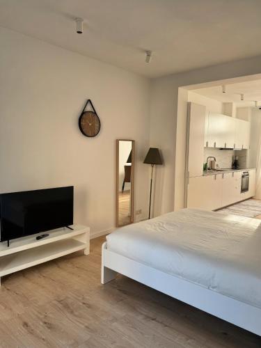 a bedroom with a bed and a flat screen tv at Bora Apartment in Brussels