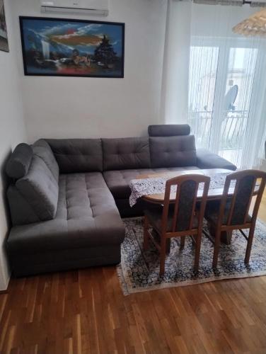 a living room with a couch and a table and chairs at Villa Maria in Jesenice