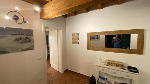 a person taking a picture in a mirror on a wall at Villa Sofia in Marina di Campo