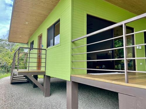 a green house with a staircase on the side of it at Casa Morpho in Zancudo