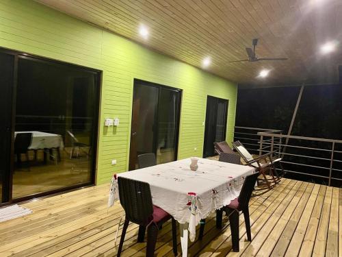 a room with a table and chairs on a deck at Casa Morpho in Zancudo