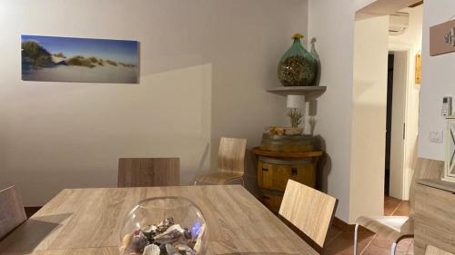 a dining room with a wooden table and chairs at Villa Sofia in Marina di Campo