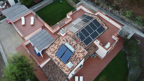 an overhead view of a house with solar panels on it at Villa Sofia in Marina di Campo